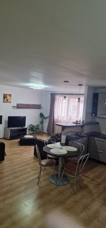 an empty living room with a table and chairs at DD's place in Sibiu