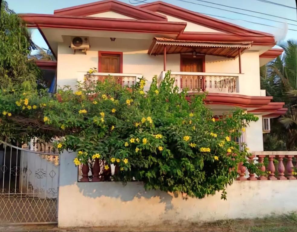 a house with flowers in front of it at GA Fernandes house in Colva