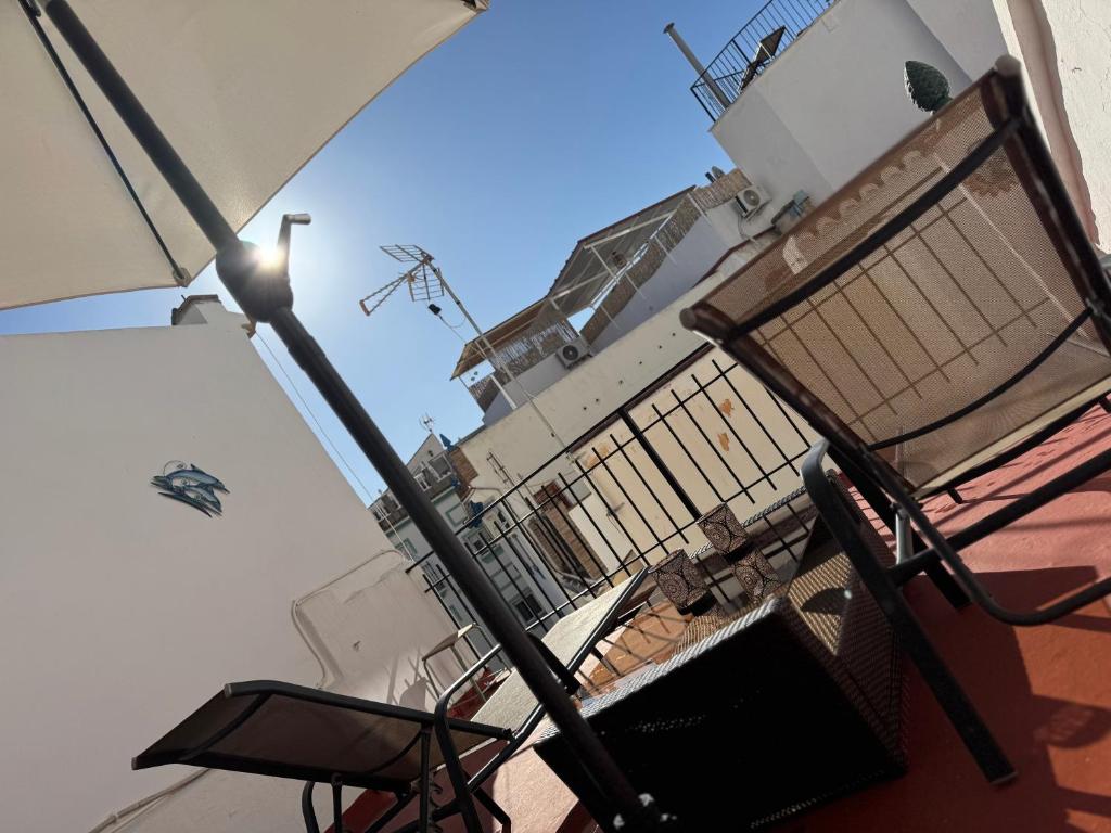 a balcony with a bench and a light pole at Mil House in Cómpeta
