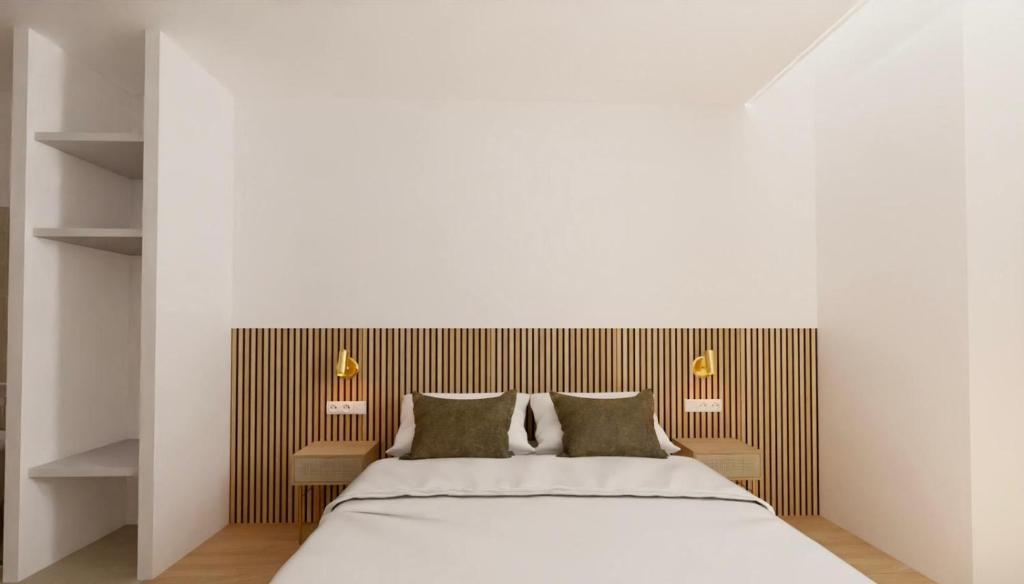 a bedroom with a large bed with two pillows at Hotel le Romanesque in Cannes