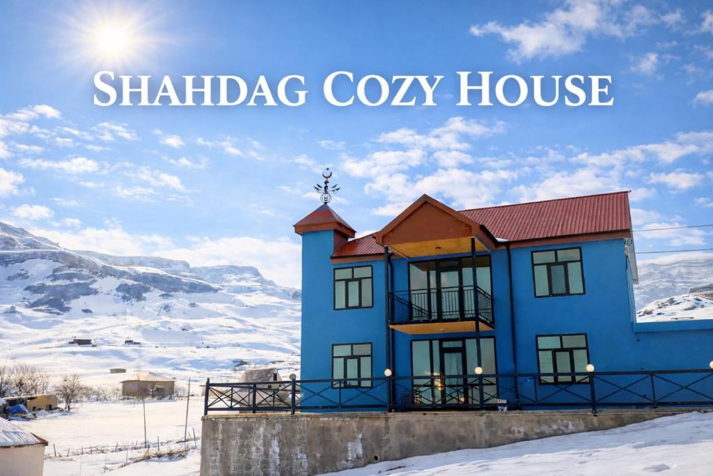 a blue house in the snow with the words shabbag cozy house at Shahdag Cozy House in Qusar