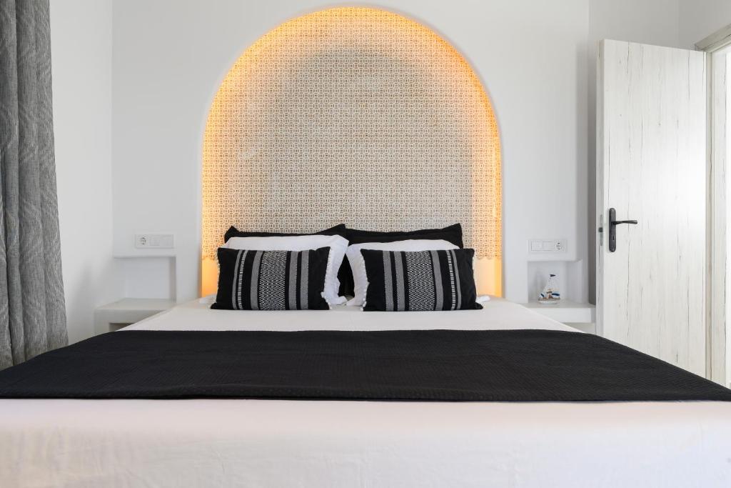 a bedroom with a large bed with a large headboard at Anemomylos in Kastraki