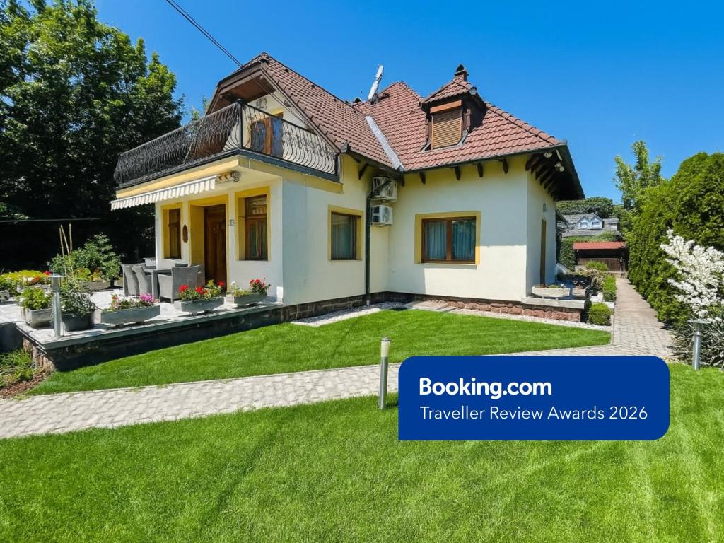 a house with a lawn in front of it at Mikes Home in Balatonfüred