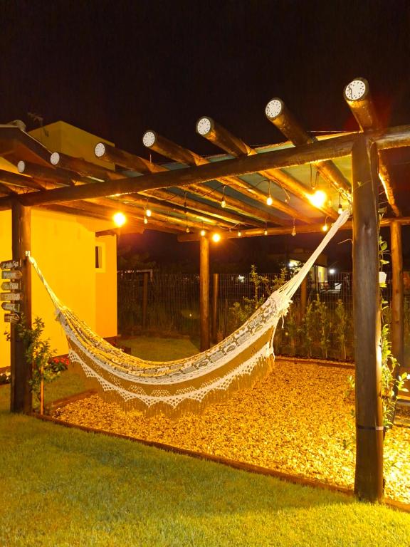 a hammock in a patio at night at Casa das Dunas in Garopaba
