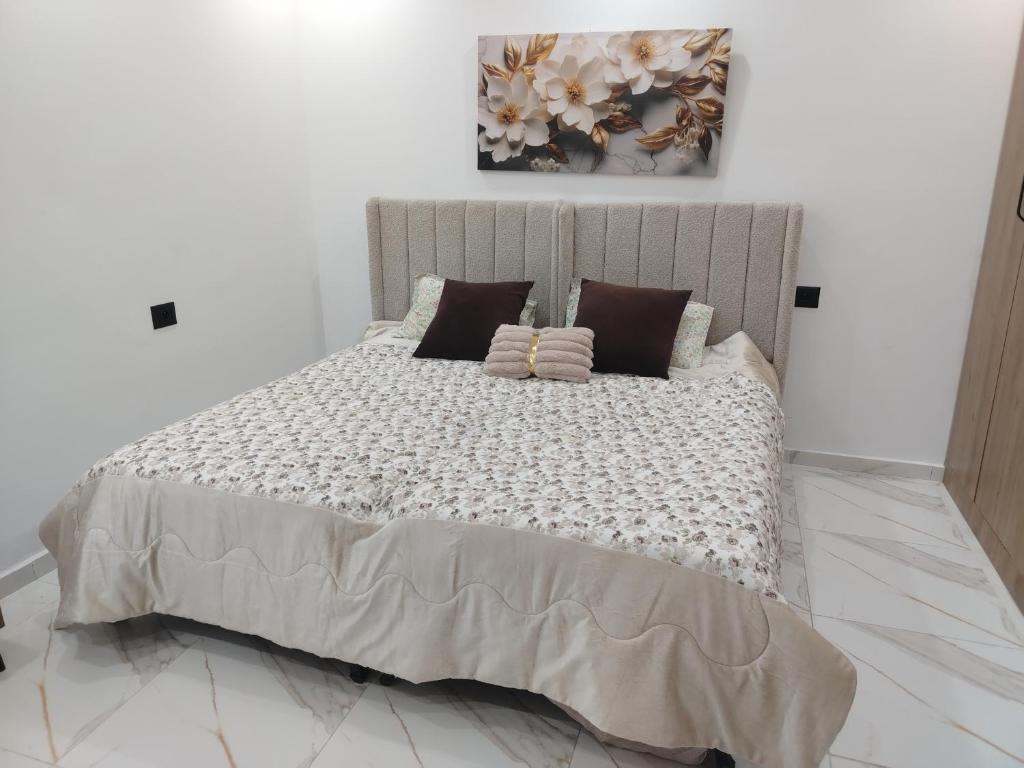 a bedroom with a large bed with pillows on it at issac in Monastir