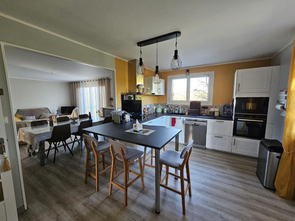 a kitchen and dining room with a table and chairs at L'Oustal in Saint-Constant