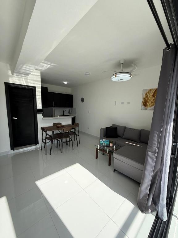 a living room with a couch and a table at Moon Apartamentos D3 in San Cristóbal