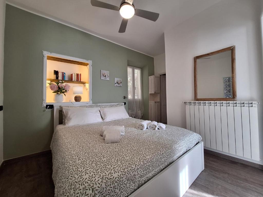 a bedroom with a bed with a ceiling fan at Casa Milda in Sanremo