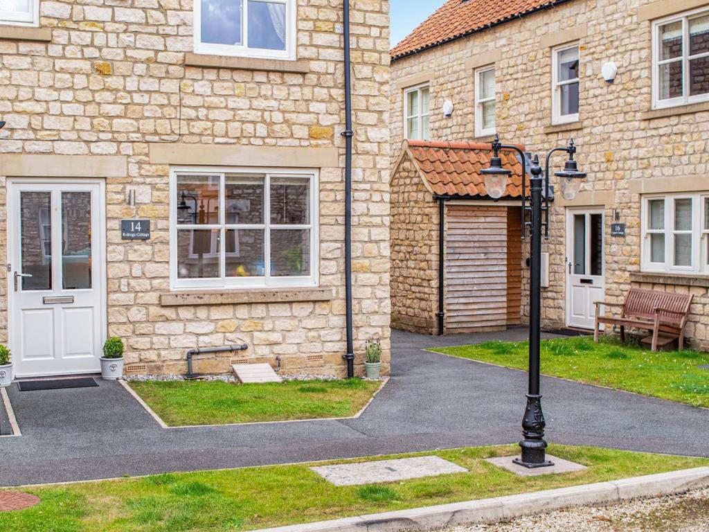 a street light in front of a brick building at Ridings Cottage in Helmsley