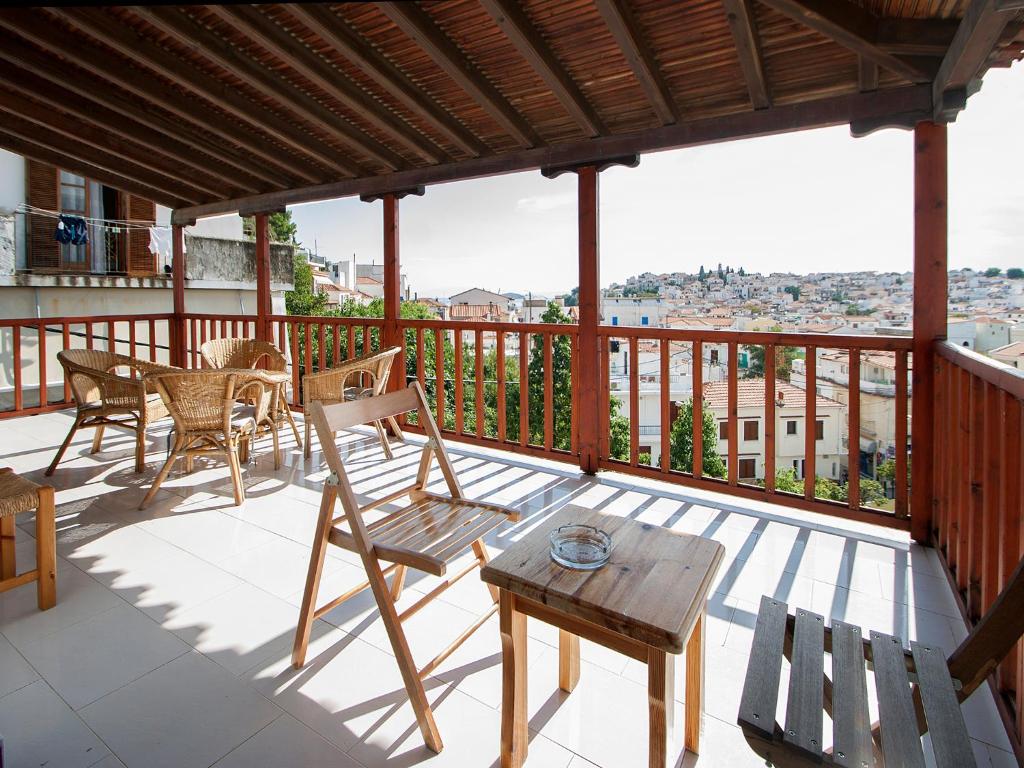 a patio with chairs and a table on a balcony at ELIZA Skiathos in Skiathos
