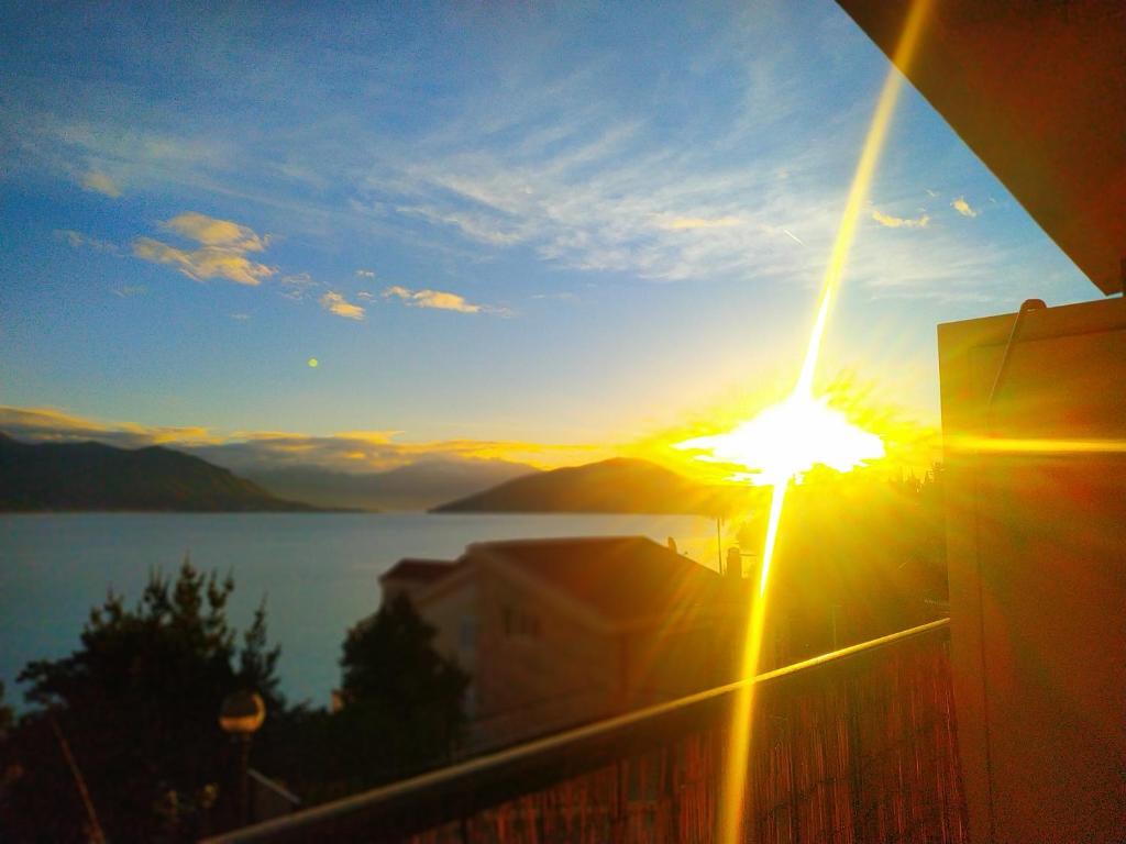 a sunset from a balcony with a view of a lake at Studio apartman Eden sea view in Njivice