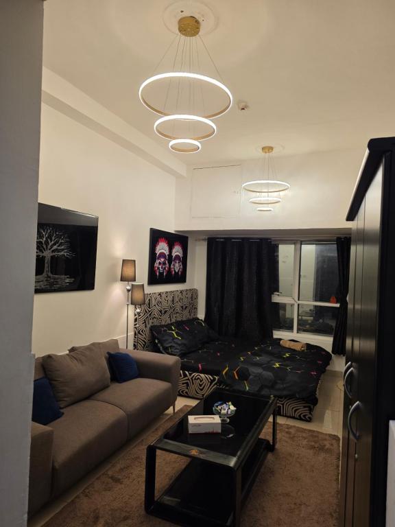 a living room with a couch and a table at Ajman Central Downtown B-50018 in Ajman 