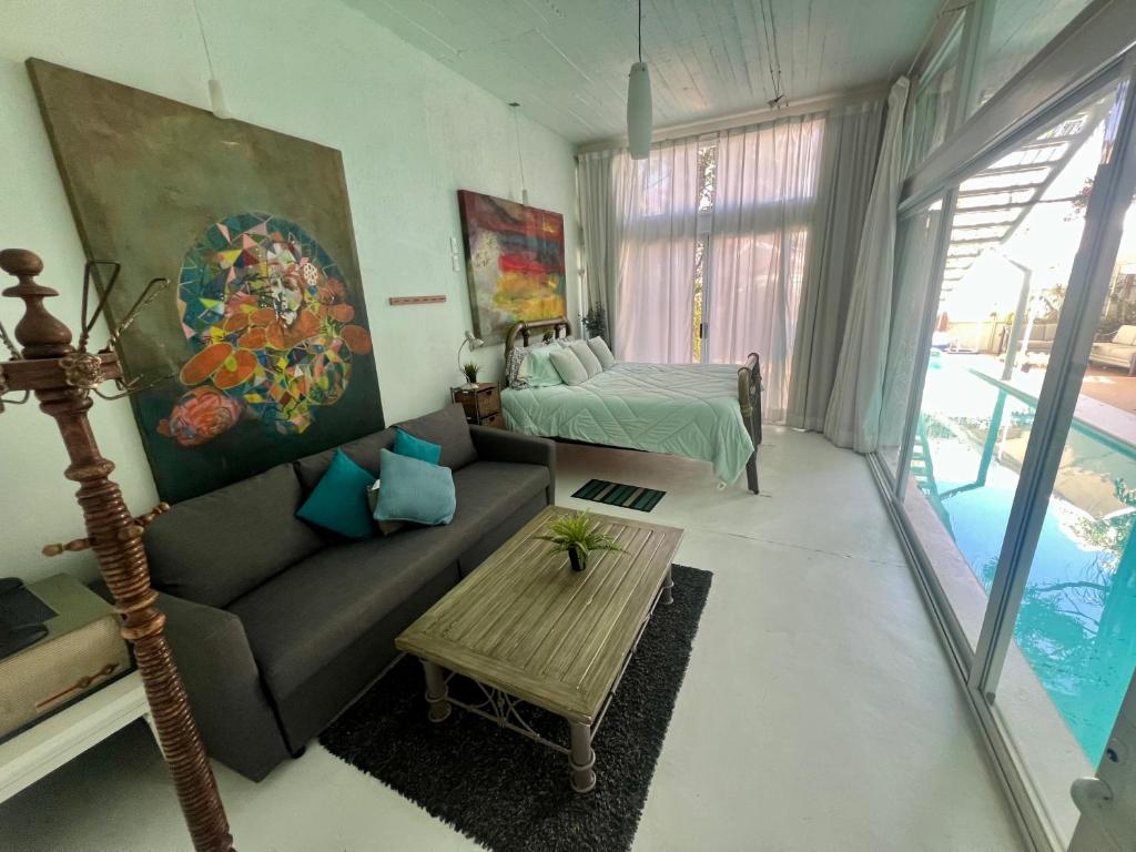 a living room with a couch and a bed at fascinating loft with swimming pool in Oaxaca City