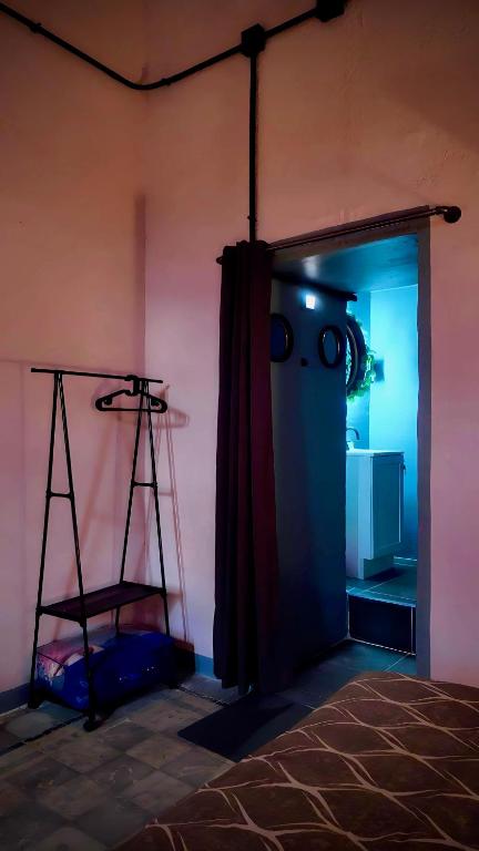 a room with a door with a ladder and a refrigerator at The Mercedes Room in Oaxaca City