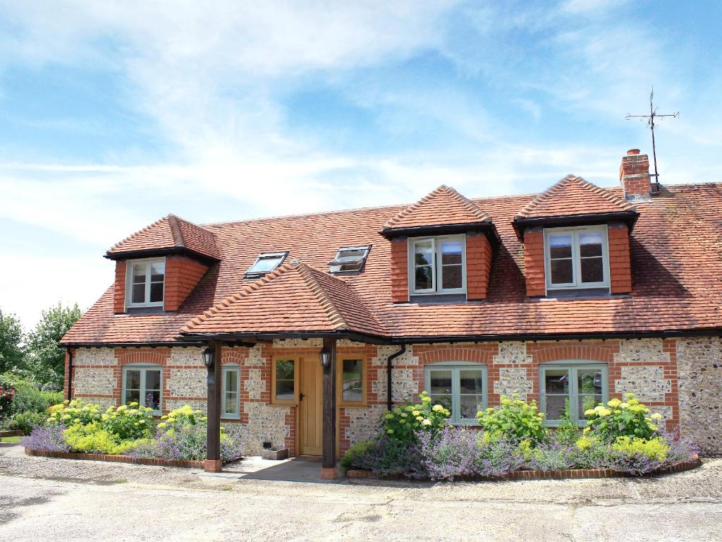 a brick house with a brown roof at The Owl House in Bishops Waltham