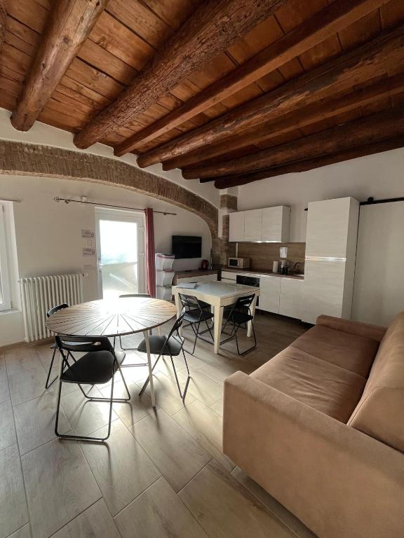 a living room with a couch and a table at DAISY Air Conditioning - Free Parking - WiFi - Self Check-in in Bergamo