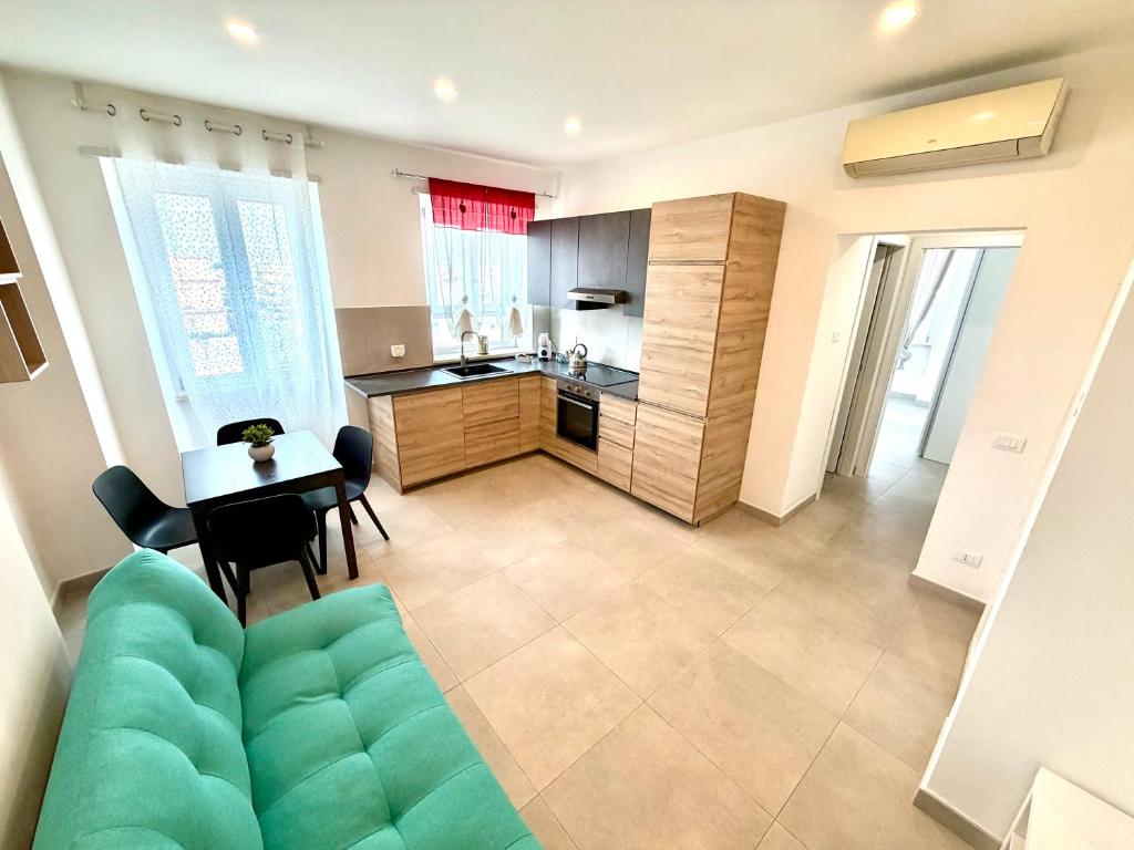 a living room with a couch and a table and a kitchen at Italy House in Ladispoli