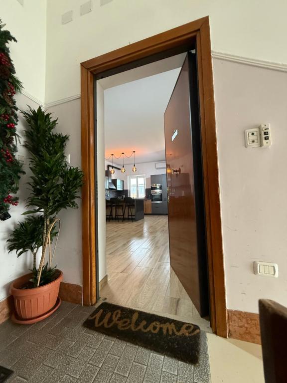 an open door with a welcome mat in a hallway at Luisella house in Isola Sacra
