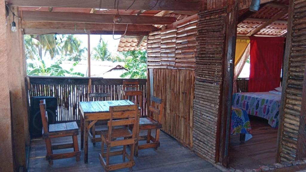 a room with a table and chairs and a bedroom at Islas de San Blas habitacion en Narasgandub in Mamartupo