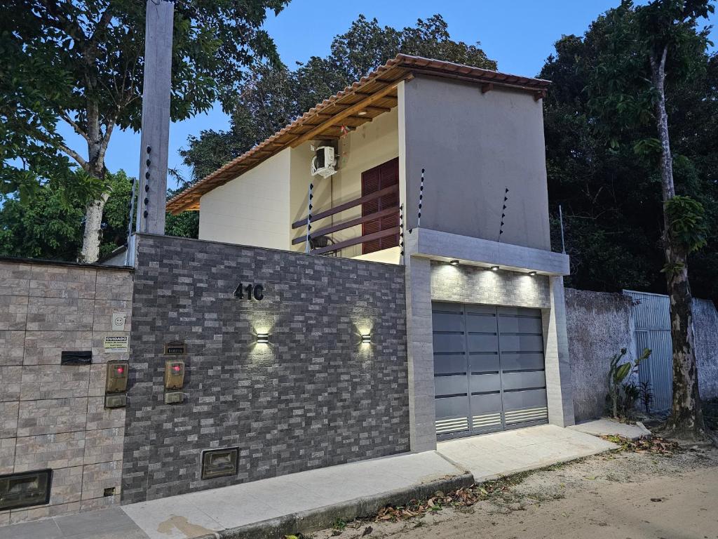 a house with a garage with lights on it at Suíte Bem Te vi in Porto Seguro