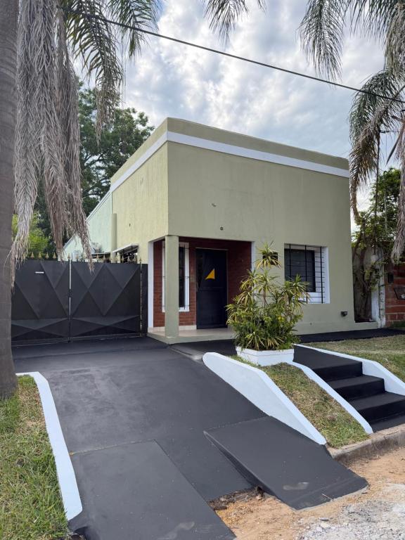 a house with a black driveway in front of it at Ana y Fran in Villa Zorraquín