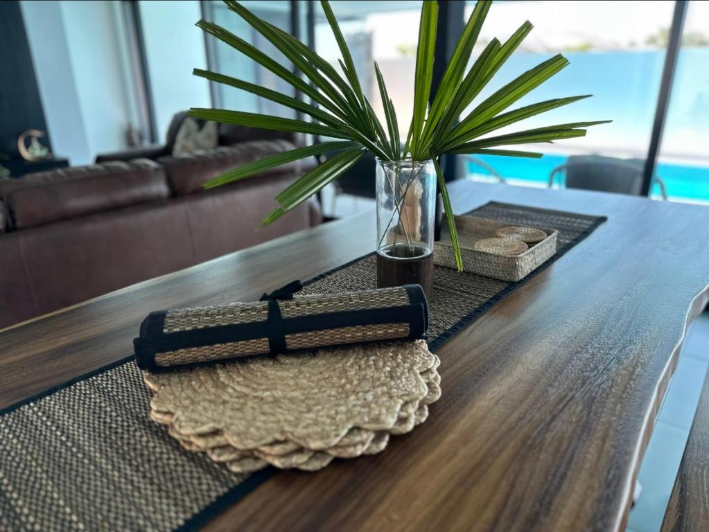 a book on a table with a plant on it at Bure 30 Luxury Villa in Nadi