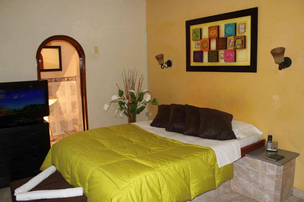 a bedroom with a bed and a flat screen tv at Hotel Ensueño in Pereira