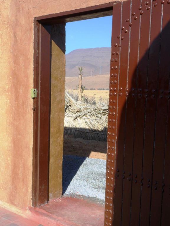 an open door with a view of the desert at Tarmguist in Tighmert
