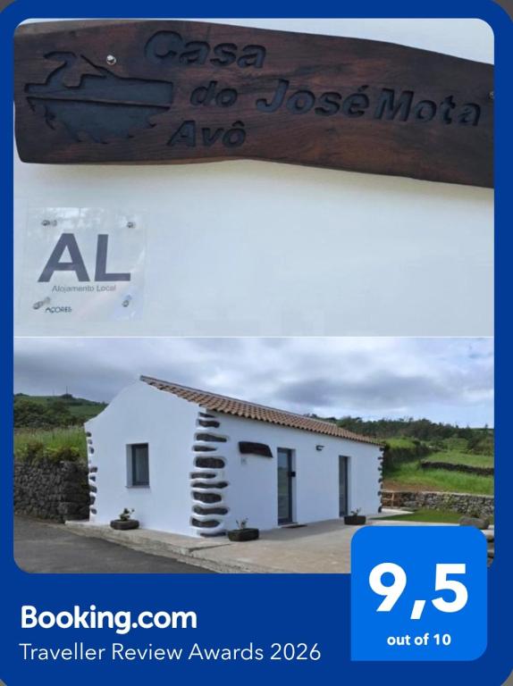 a picture of a small white building with a sign at Casa do Avô José Mota in Santa Cruz das Flores