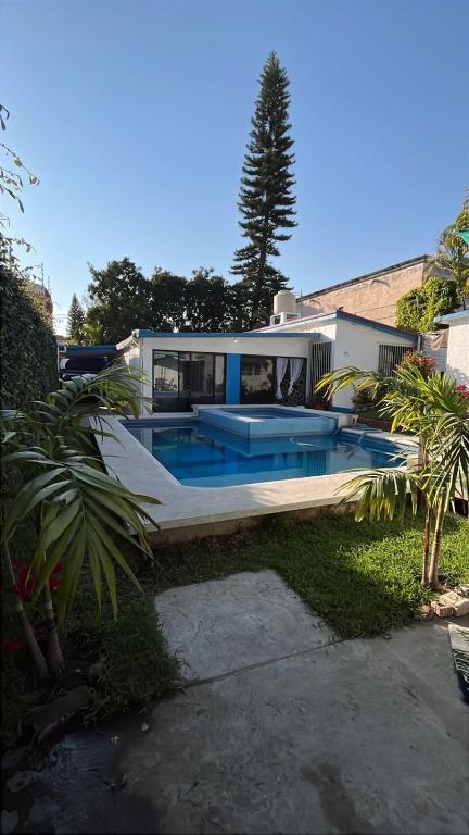 a house with a swimming pool in front of it at Casa en Cuernavaca Morelos in Cuernavaca