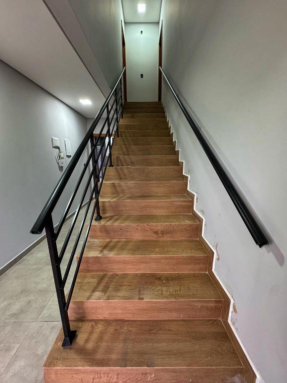 a staircase in a house with wooden floors at Pousada Ebenezer in Garopaba