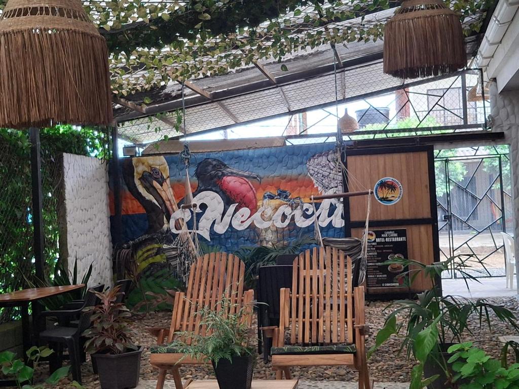 a restaurant with a mural on the side of it at Cabañas Mar Caribe in Necoclí