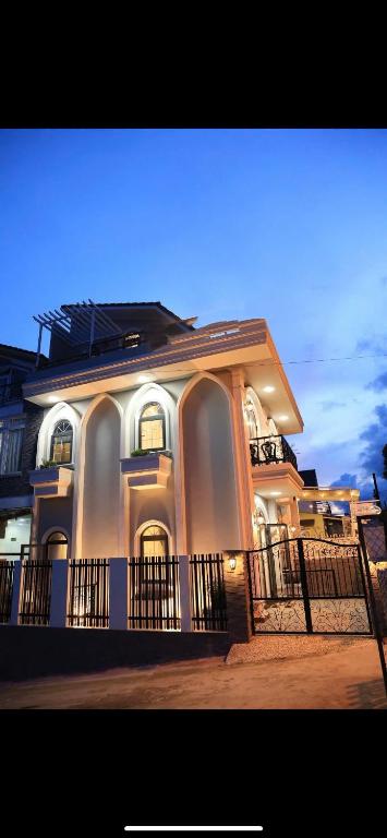 a large white building with a fence in front of it at Lumi Home Đà Lạt in Da Thanh