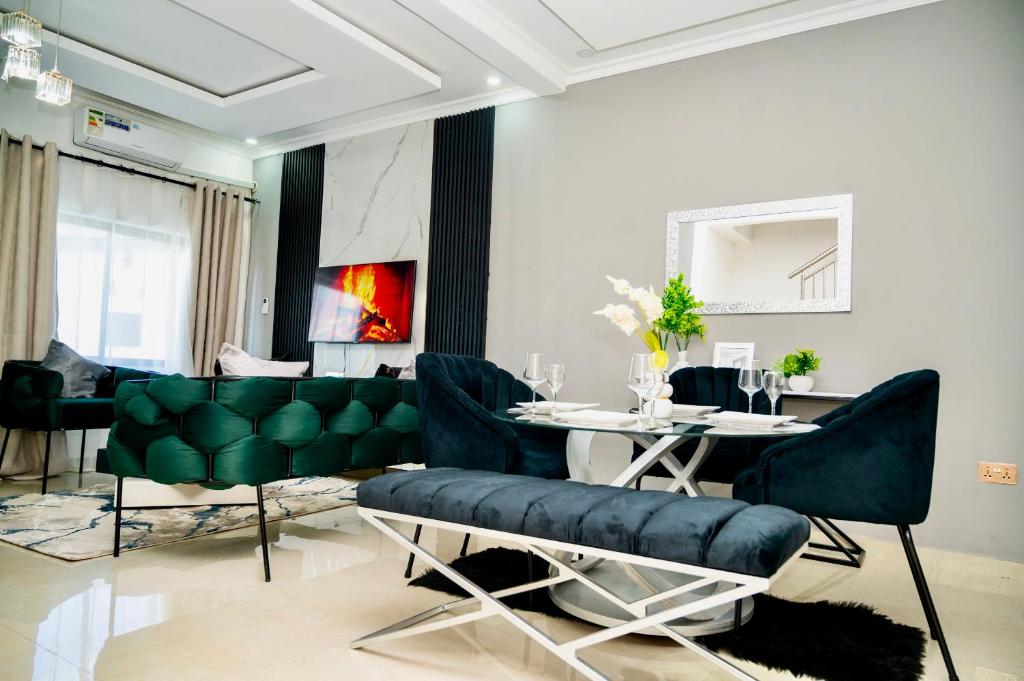 a dining room with a table and green chairs at 2nd street ibex Apartment in Lusaka