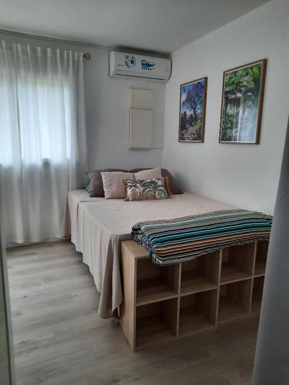 a small bedroom with a bed and a window at Leu Cosy Coco in Saint-Leu