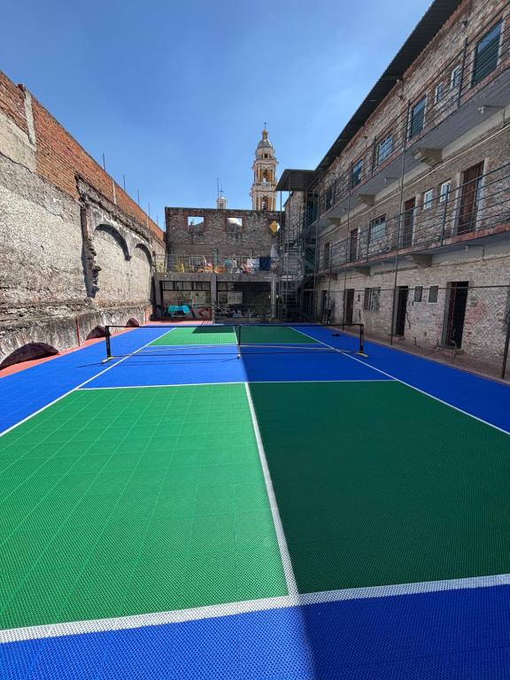 a tennis court in the middle of a building at Hostal Casa De Arcos in Puebla