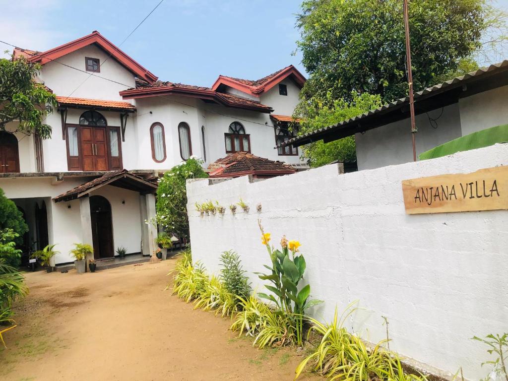 a white house with a sign in front of it at Anjana Villa in Katunayaka