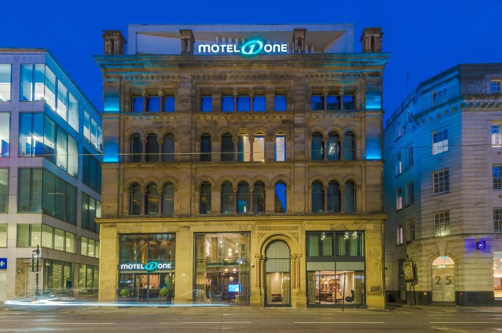 a building with a sign on the top of it at Motel One Manchester-Royal Exchange in Manchester
