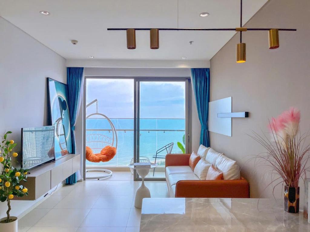 a living room with a view of the ocean at Căn hô The Song Du lịch Biển Tháp Tam Thắng Infinity Pool - Sophia Home in Vung Tau