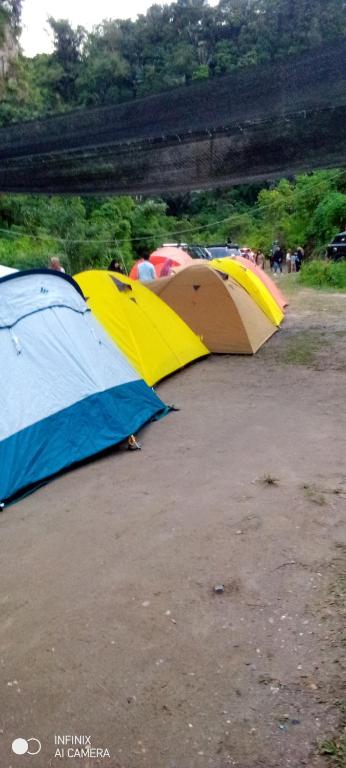 a group of tents sitting on the ground at Sikumbang camp in Bukittinggi