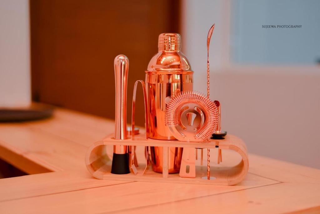 an orange blender sitting on top of a table at The Euro Lounge in Rambukkana