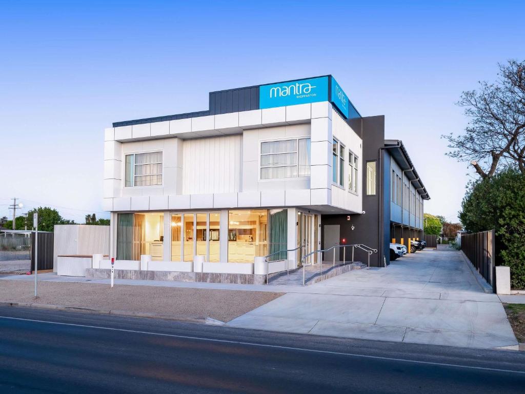 a large white building with a sign on it at Mantra Shepparton in Shepparton