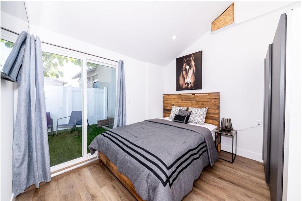 a bedroom with a bed and a large window at Stellar Sherman Oaks One Bedroom close to Universal Studios in Burbank
