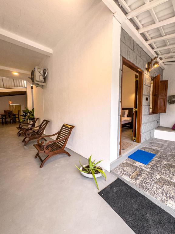 a room with chairs and a couch and a table at Tidal Nest in Weligama