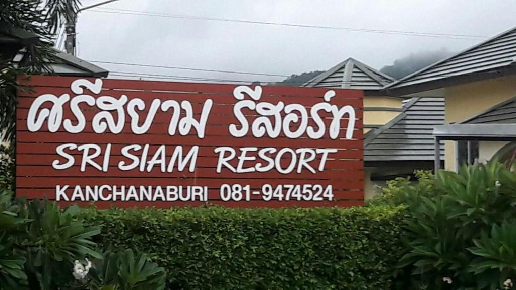 a sign for a sasanian restaurant in front of a house at Sri Siam Resort in Kanchanaburi City