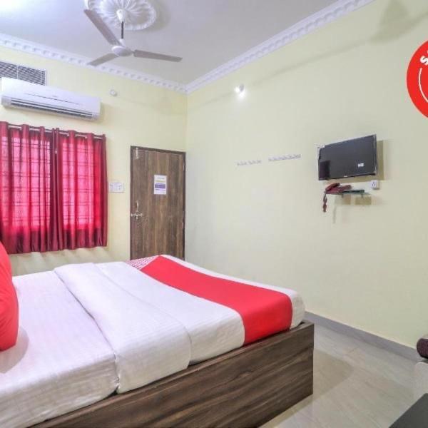 a bedroom with a bed and a tv on the wall at Hotel kashish in Waigaon