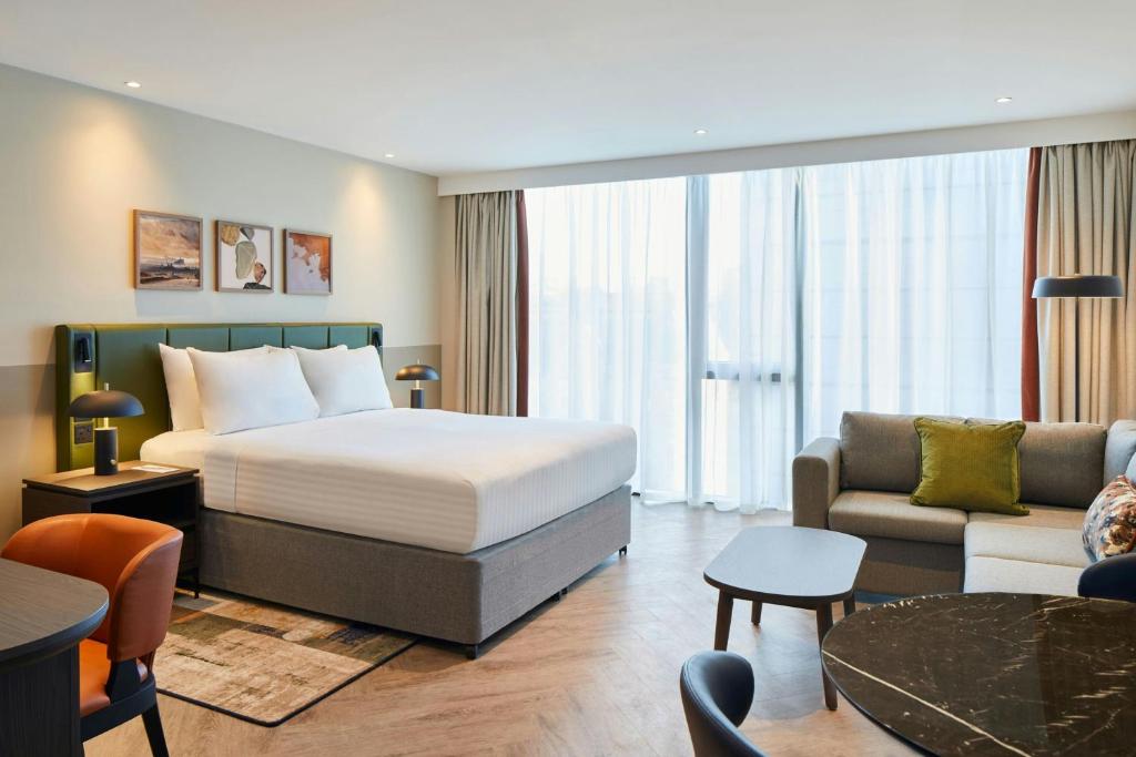 a hotel room with a bed and a living room at Residence Inn by Marriott Edinburgh in Edinburgh