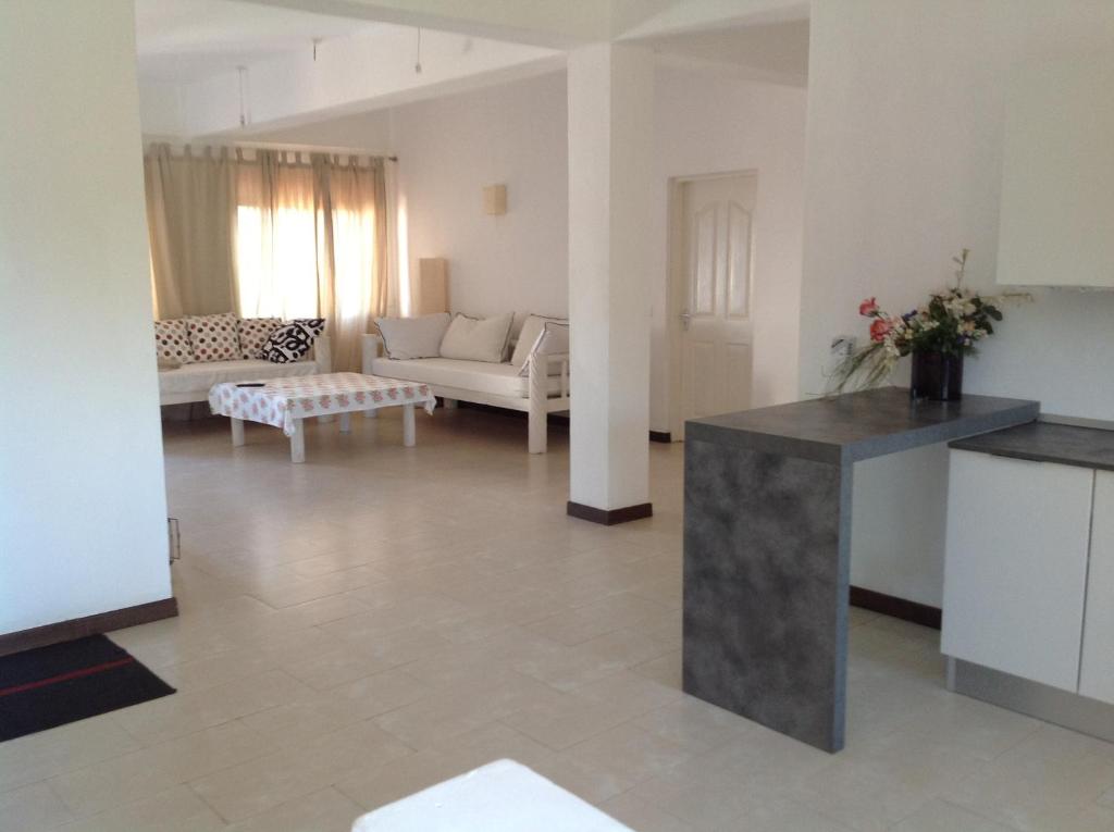 a living room with a couch and a table at Ripasso Apartments in Malindi