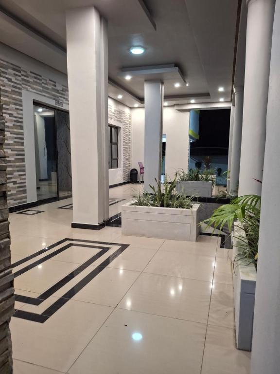 a large lobby with plants in a building at Silk Mbare Guest House in Manzini