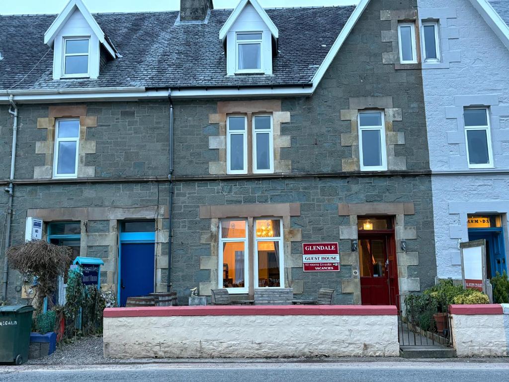 a brick building with a for sale sign in front of it at Glendale Guesthouse in Oban